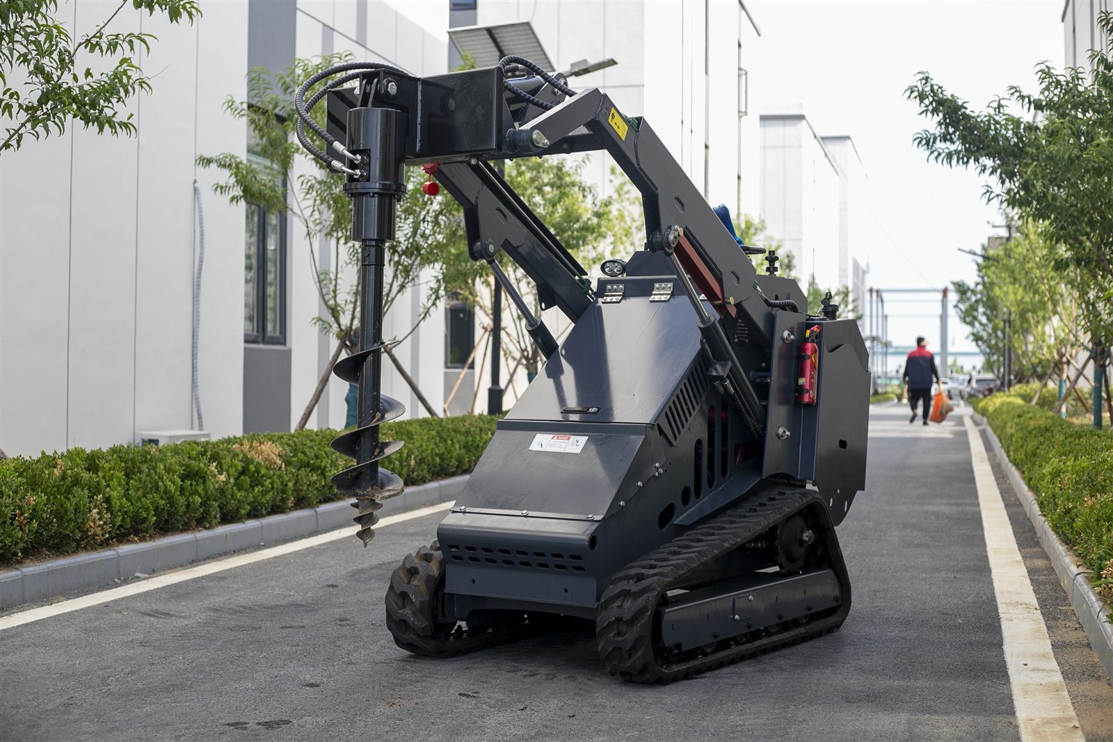 Compact loader with earth auger attachment