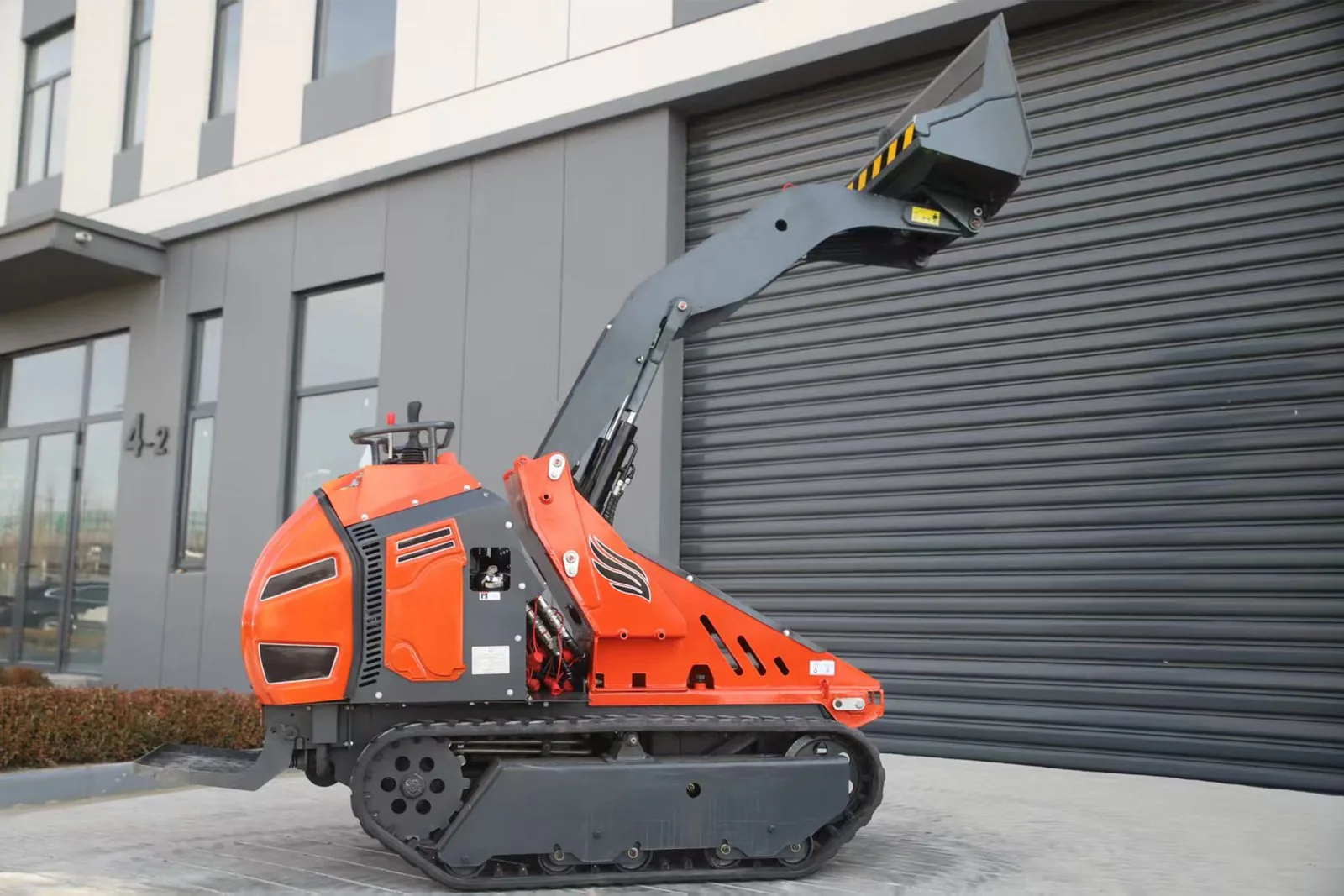 C1200 compact crawler loader at maximum lift position