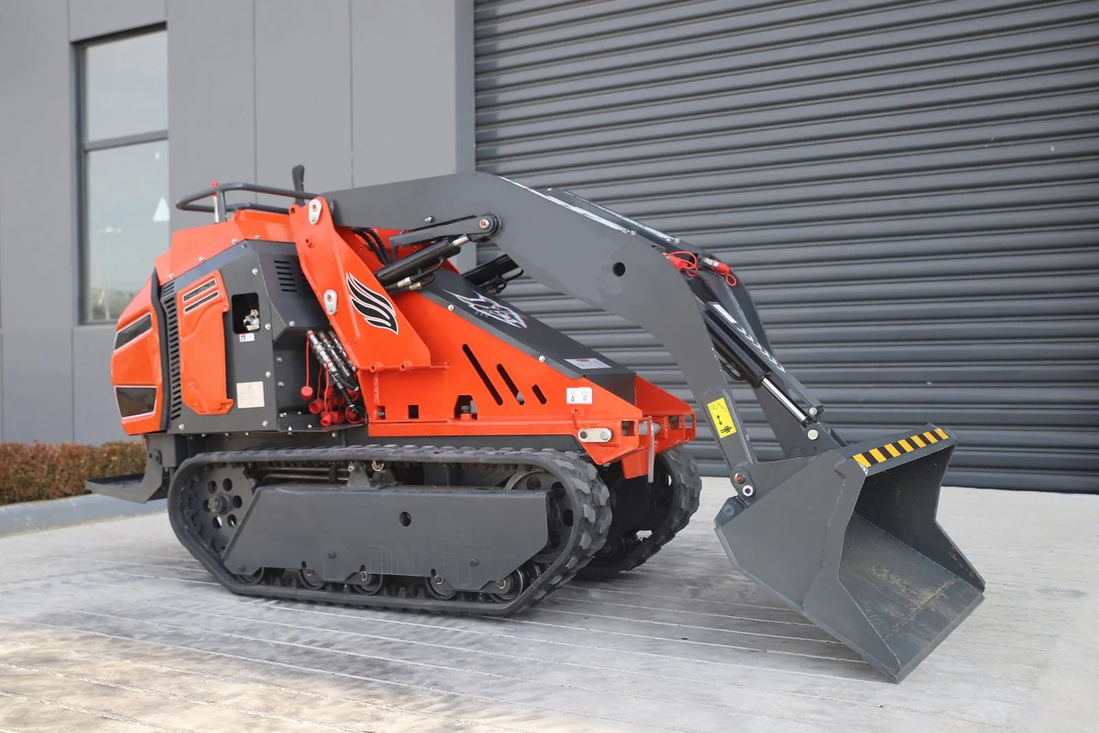 C1200 mini tracked loader with raised loading bucket