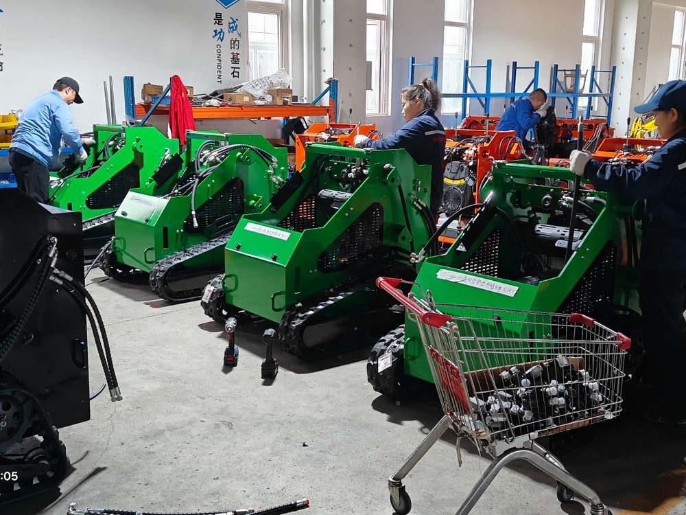Technicians assembling compact skid steer loaders in the workshop