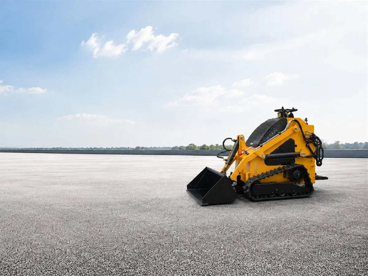 KORVA T360 tracked mini skid steer loader with rubber tracks at an industrial site