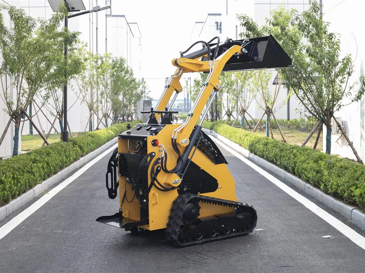 KORVA T360 tracked mini skid steer loader with bucket raised for loading work
