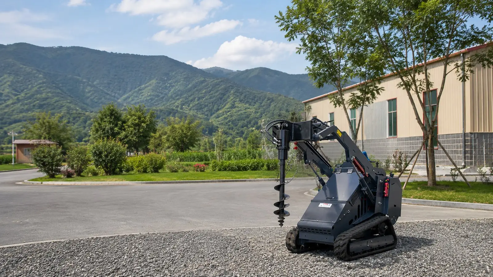 KORVA mini skid steer loader with auger attachment working on outdoor ground